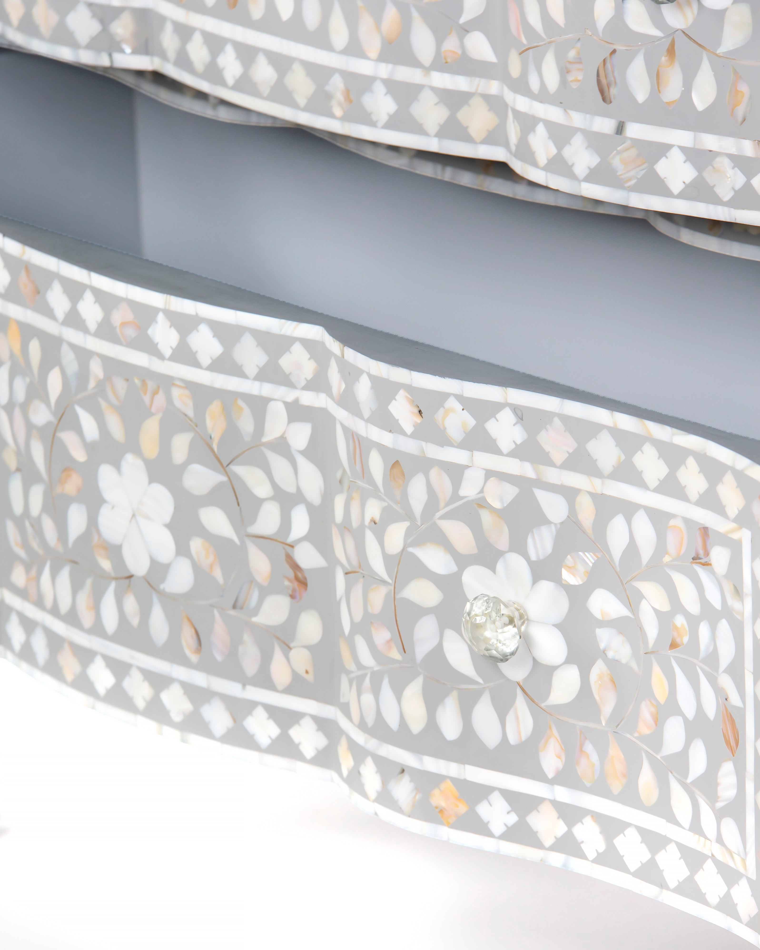 Floral mother of pearl motif detail on grey drawer front