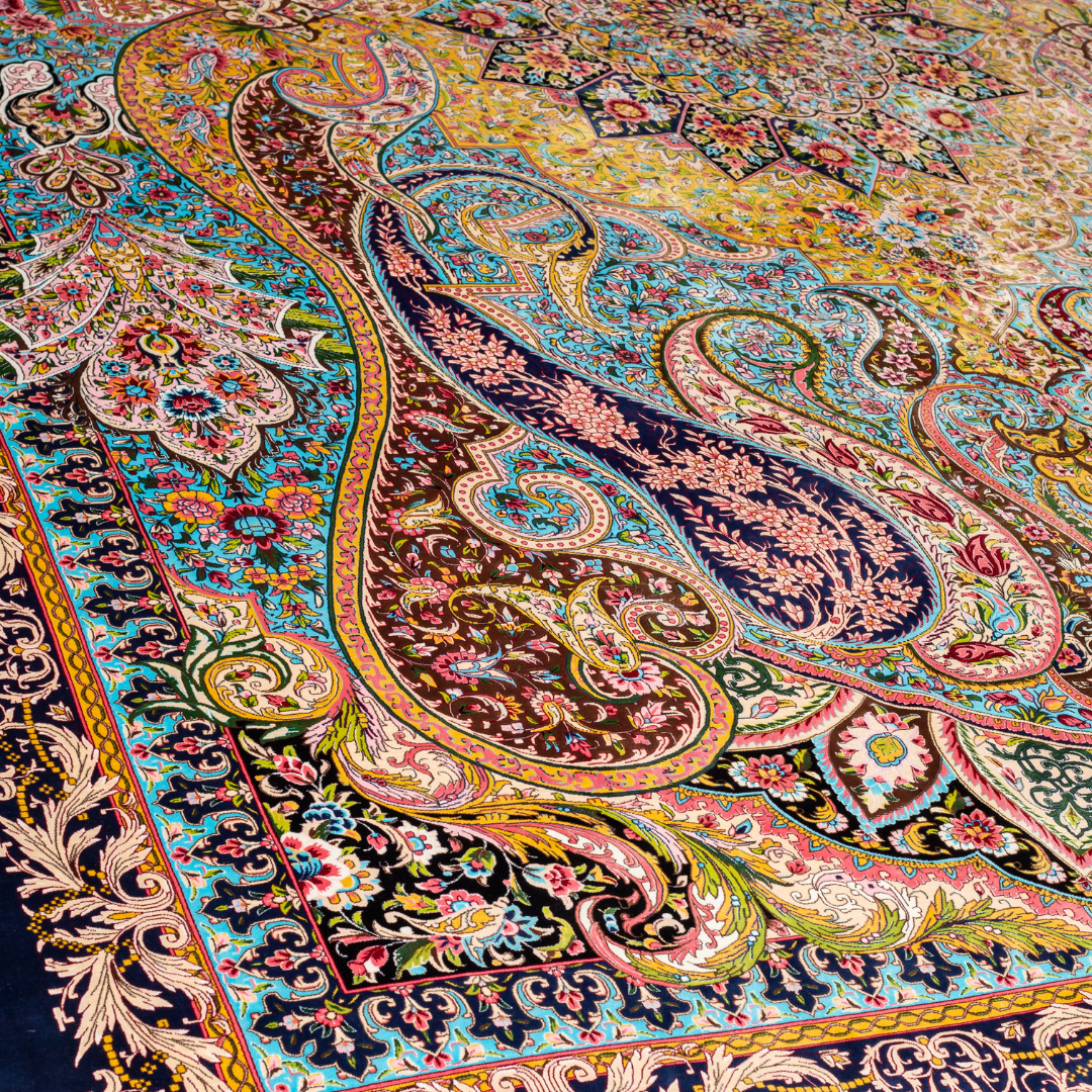 High-detail silk rug featuring a central medallion, ornate paisleys, and floral motifs in jewel tones. Perfect for elegant interiors.