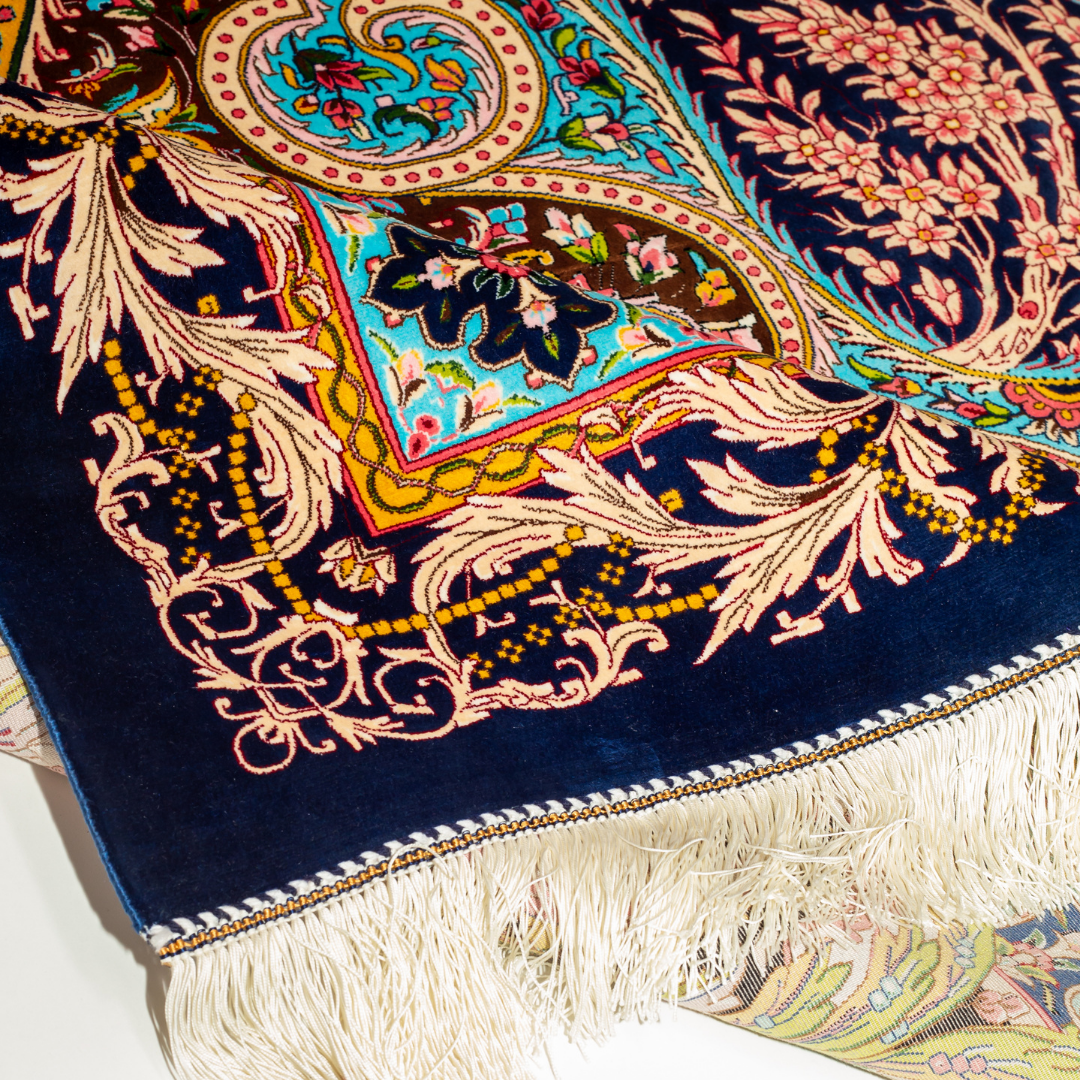 High-detail silk rug featuring a central medallion, ornate paisleys, and floral motifs in jewel tones. Perfect for elegant interiors.