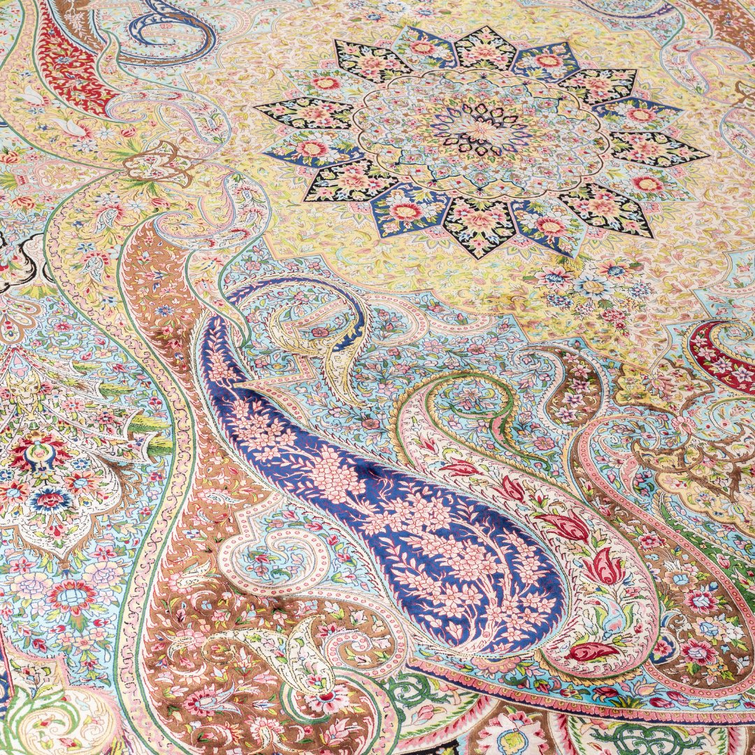 High-detail silk rug featuring a central medallion, ornate paisleys, and floral motifs in jewel tones. Perfect for elegant interiors.