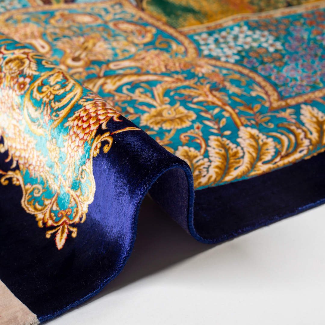 Elegant silk rug with flying birds and floral tree scene, bordered in ornate gold and blue. Handwoven with incredible detail and texture.