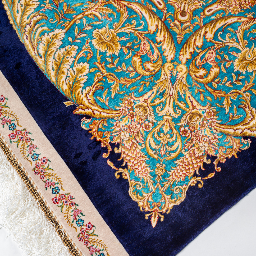 Elegant silk rug with flying birds and floral tree scene, bordered in ornate gold and blue. Handwoven with incredible detail and texture.