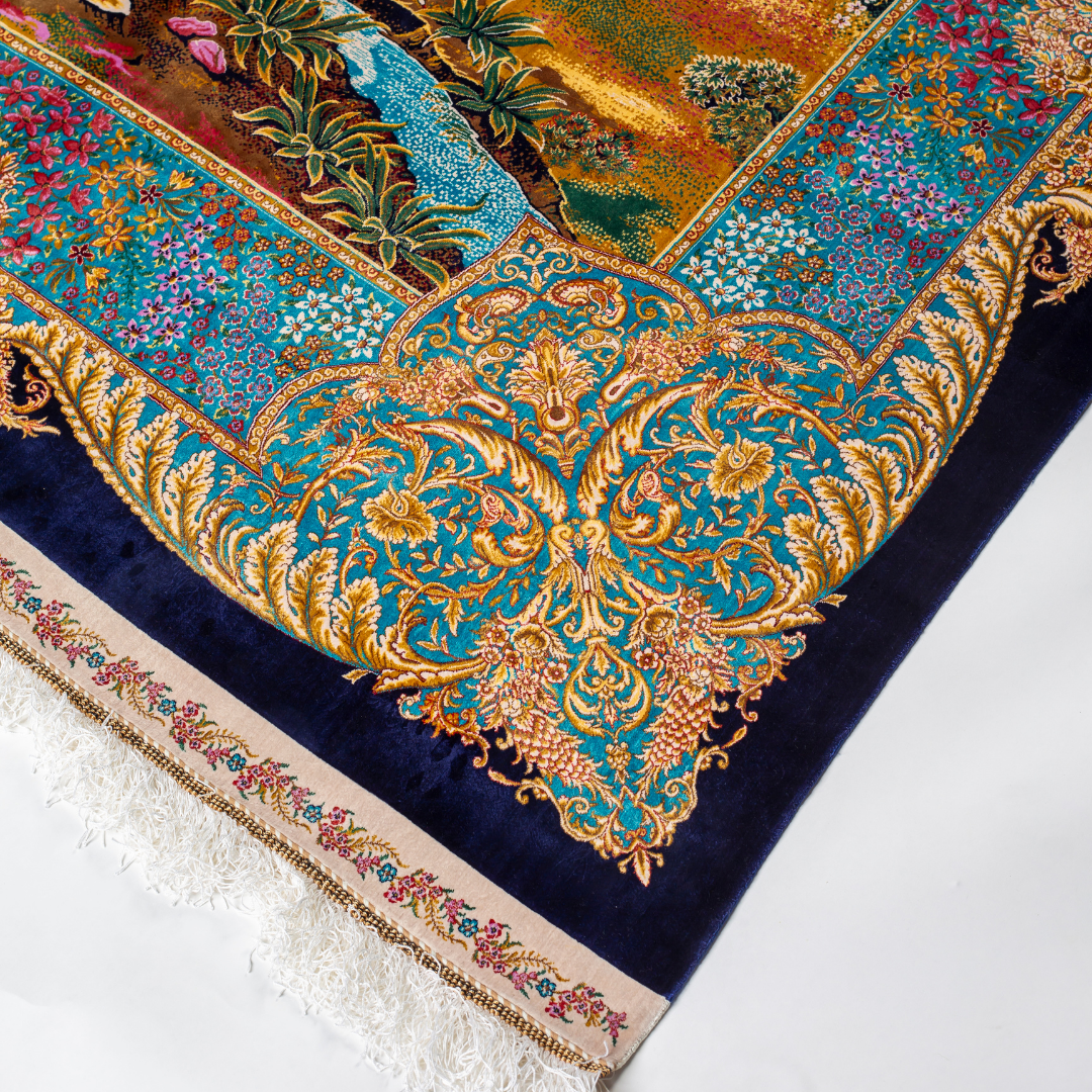 Elegant silk rug with flying birds and floral tree scene, bordered in ornate gold and blue. Handwoven with incredible detail and texture.