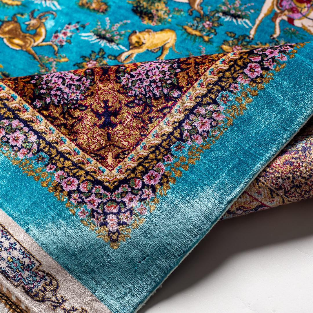 Exquisite silk rug in turquoise blue with detailed horsemen, floral borders, and intricate golden animal motifs, measuring 150x100 cms.