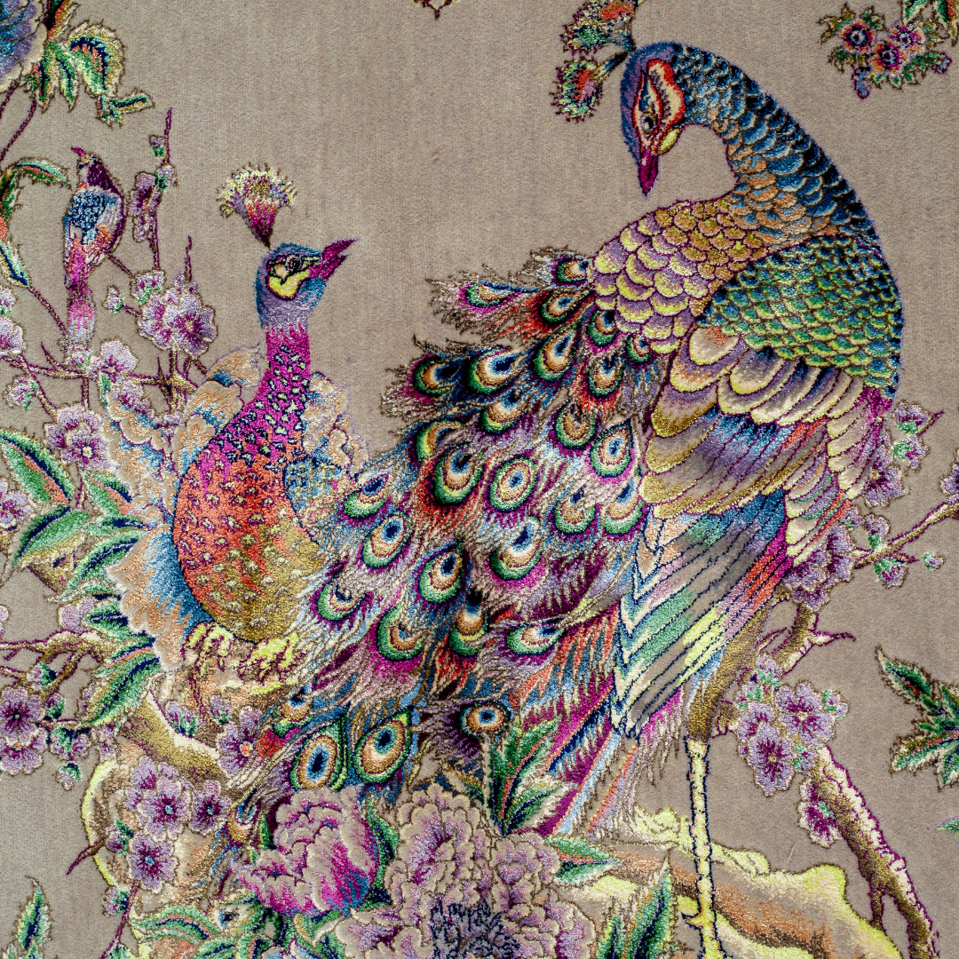 Elegant silk rug with peacock and floral design in soft pastels. Framed by intricate vine borders. A handwoven masterpiece of grace.