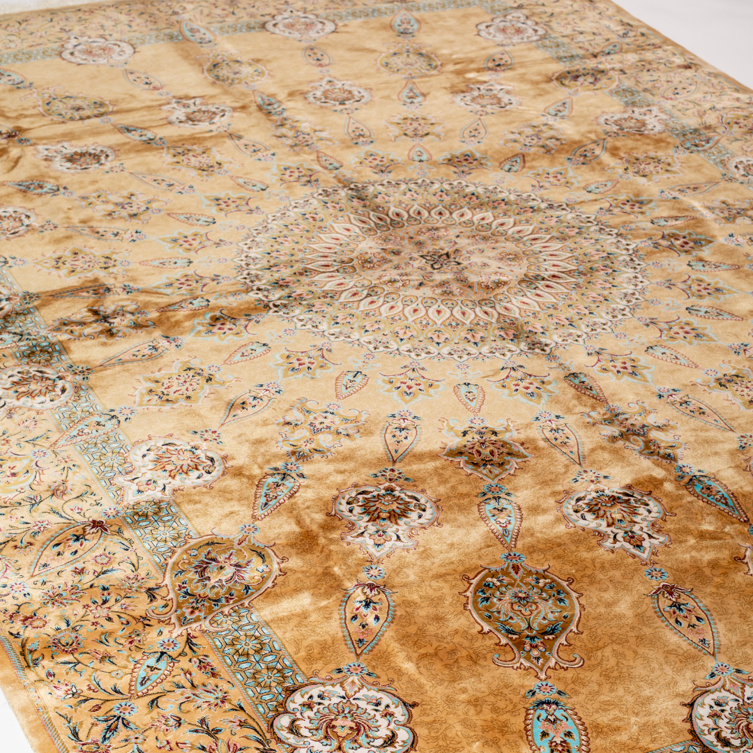 Golden silk rug featuring a central medallion, floral border, and teal highlights, shown in detailed close-ups and full view.