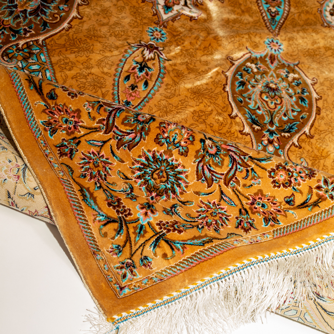 Golden silk rug featuring a central medallion, floral border, and teal highlights, shown in detailed close-ups and full view.