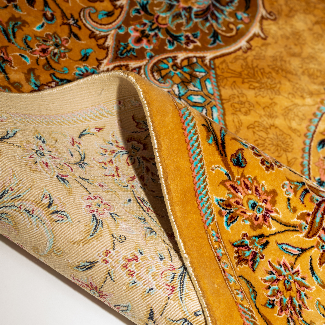 Golden silk rug featuring a central medallion, floral border, and teal highlights, shown in detailed close-ups and full view.