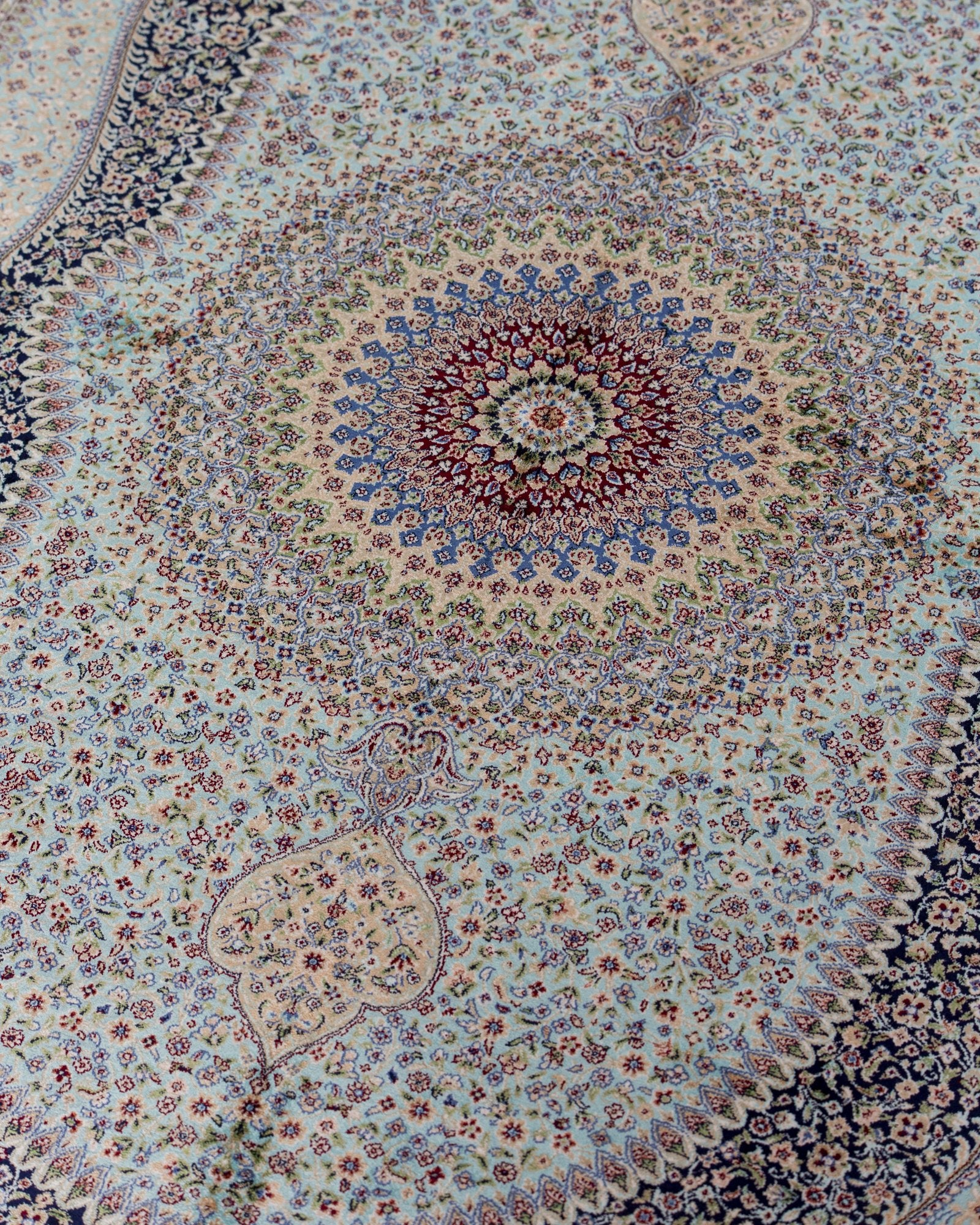 corner with silk fringe on the Nasrin blue silk rug
