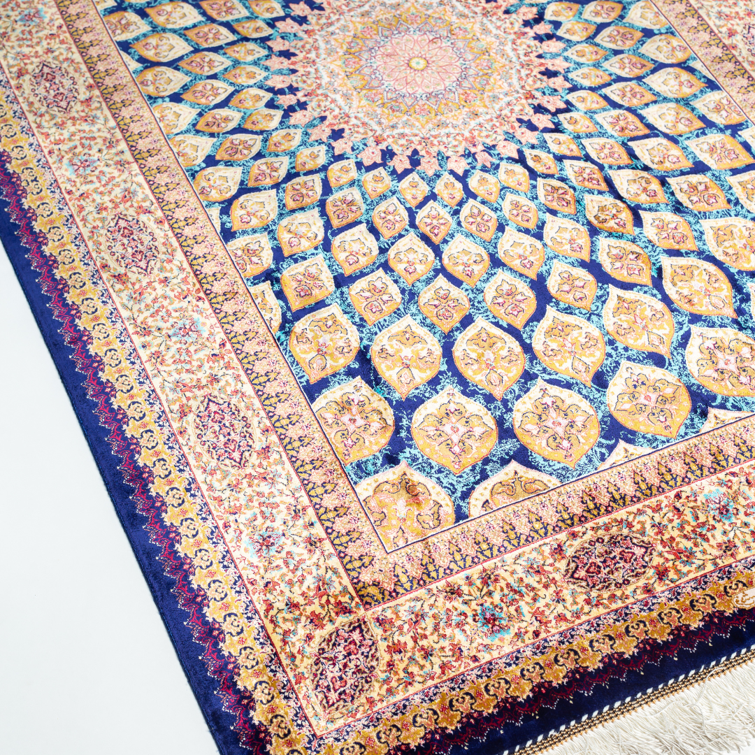Navira silk rug featuring a medallion and floral design in navy, ruby, teal, and ivory. Size: 150x100 cms.