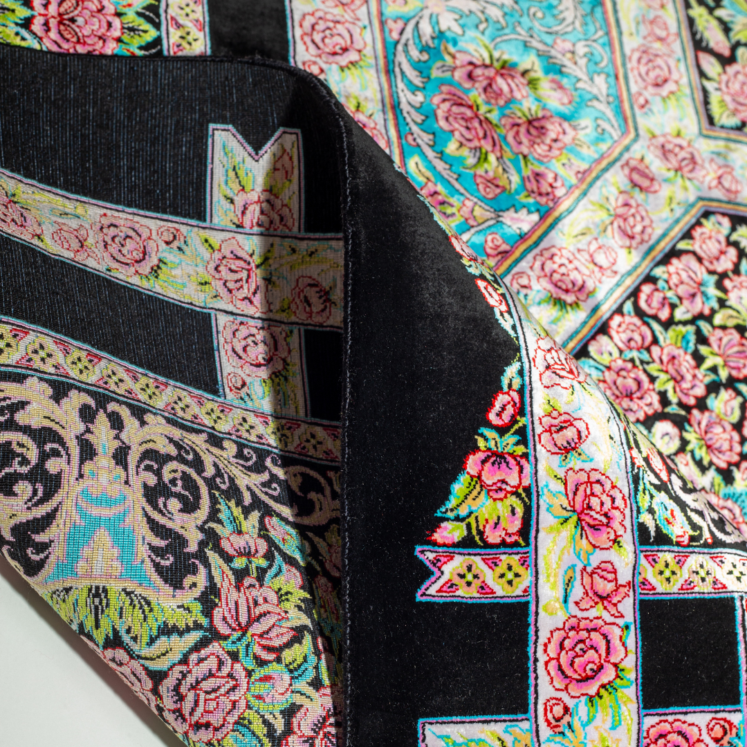 200x300 cm black silk rug with vivid pink rose motifs, turquoise borders, and central medallion. Intricate hand-knotted floral design.