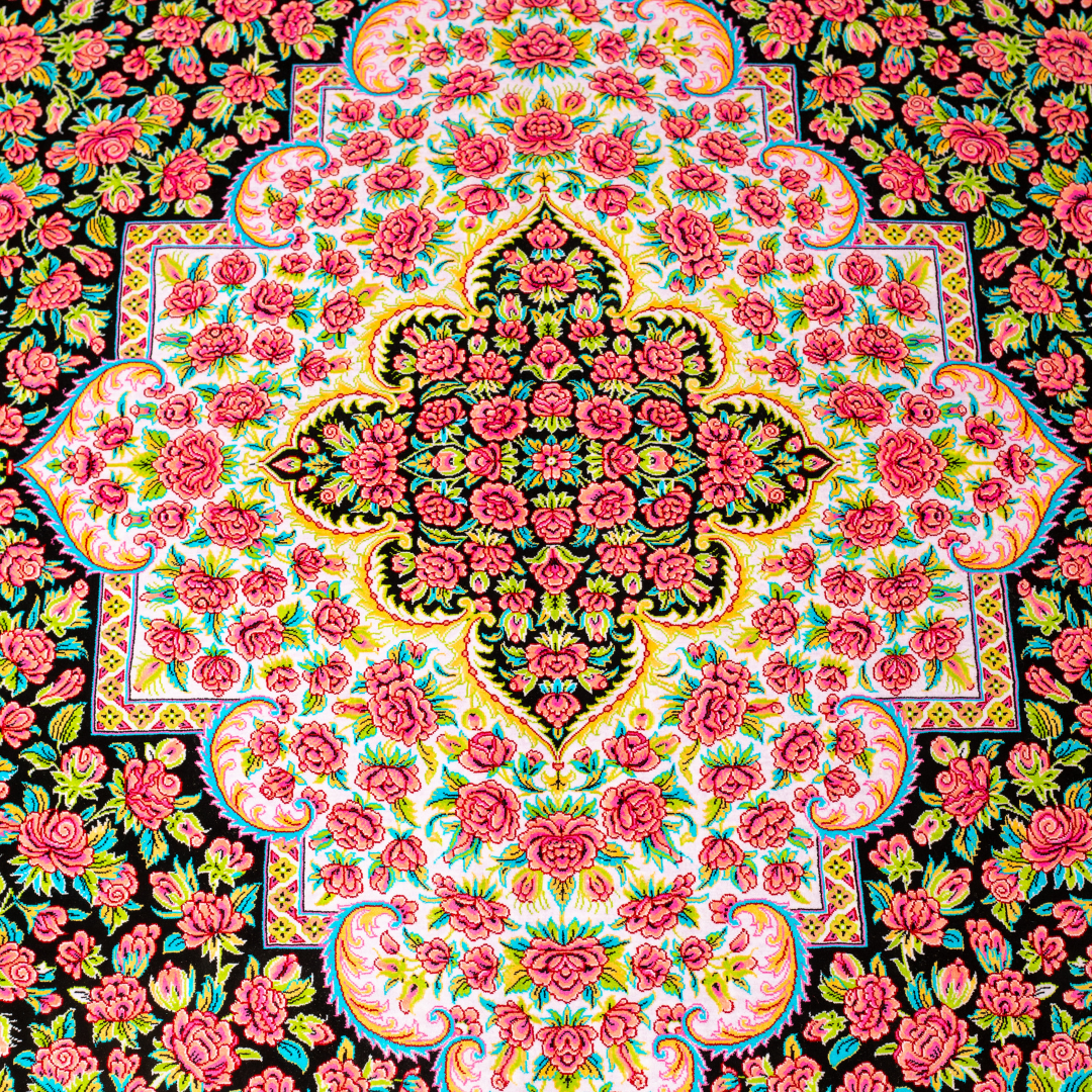 200x300 cm black silk rug with vivid pink rose motifs, turquoise borders, and central medallion. Intricate hand-knotted floral design.