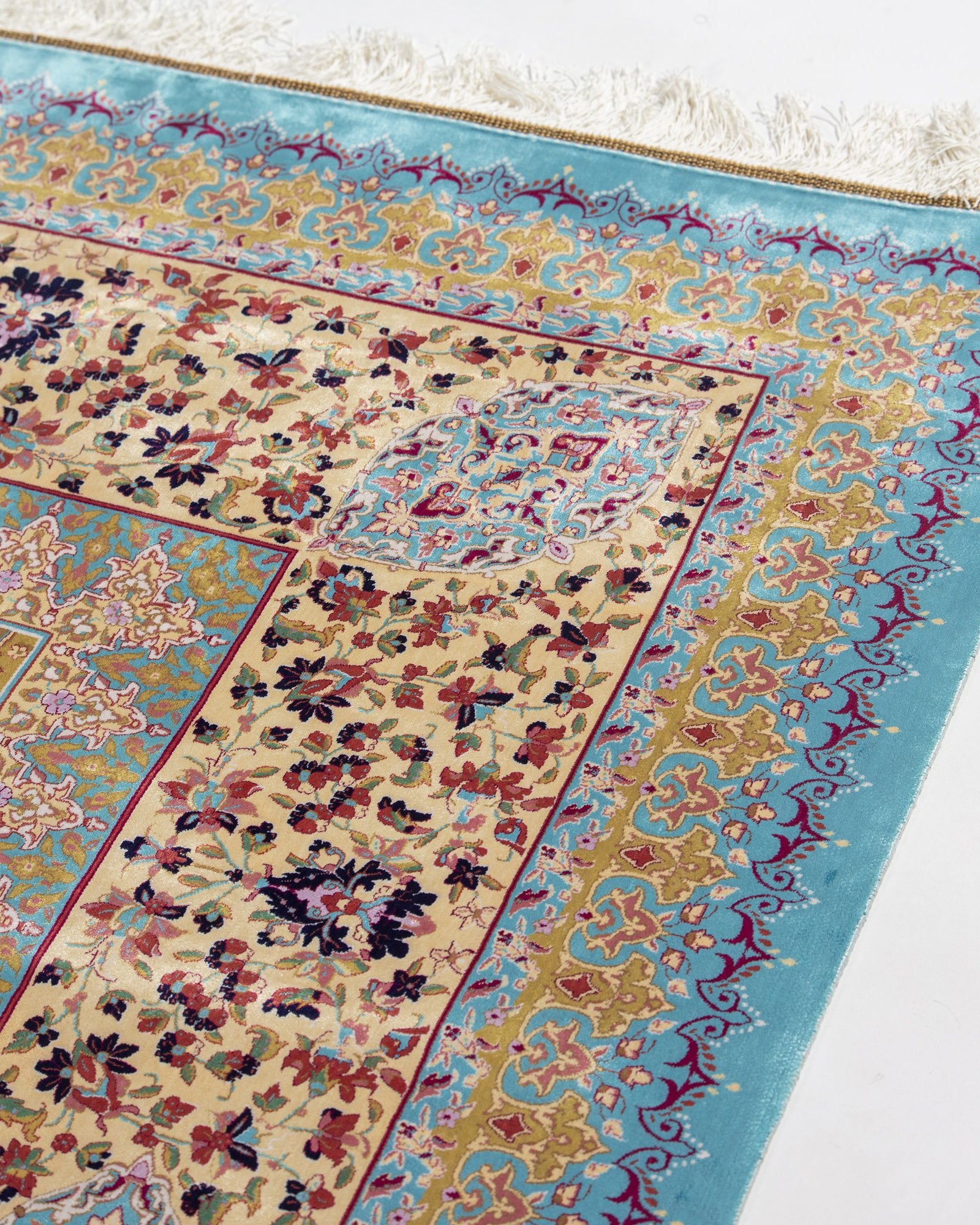 Ophira silk carpet angled view showing turquoise and gold tones, 250 x 350 cm - Tabeer Homes Dubai