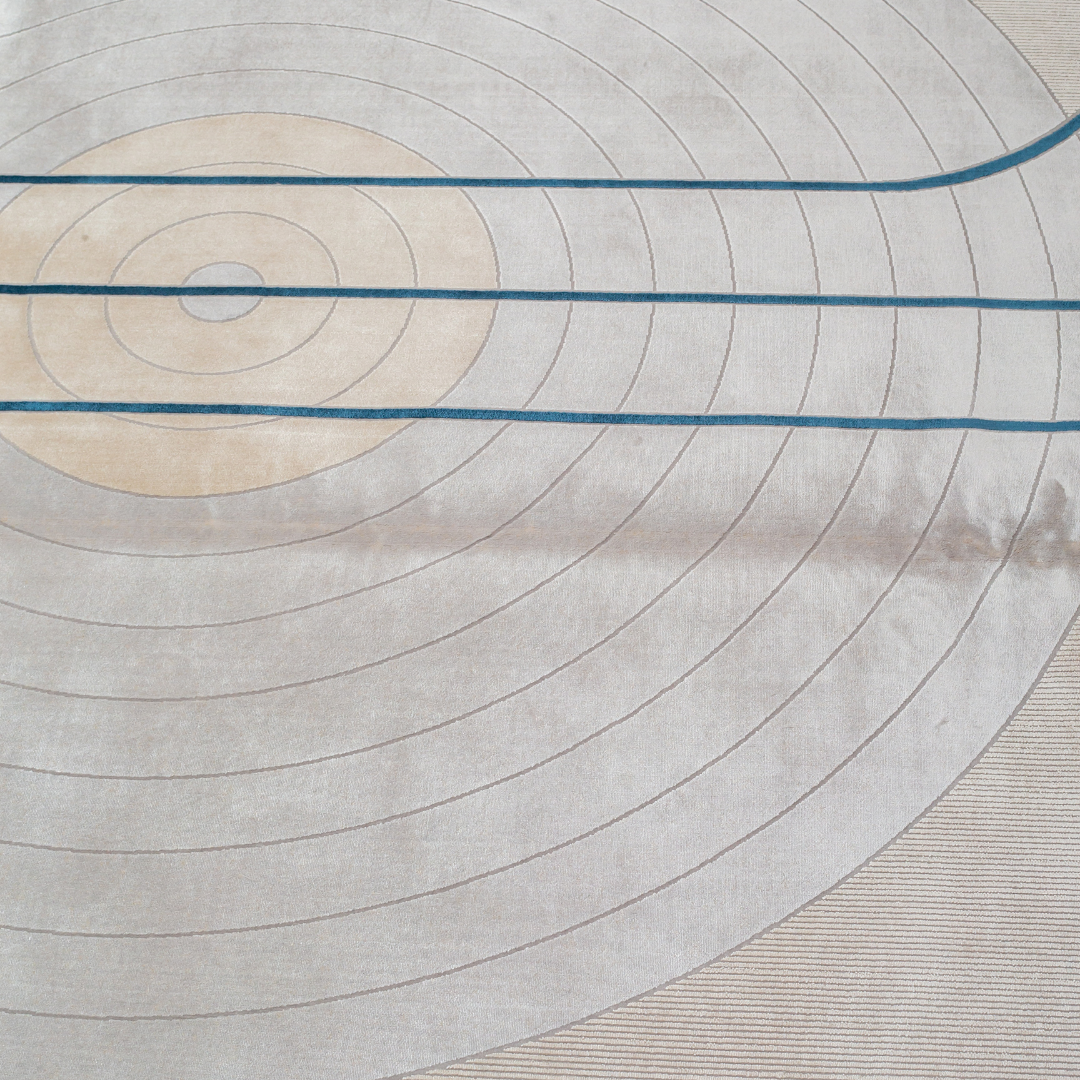 Orrin cotton Rug in 200x300 cm featuring beige and ivory tones with minimal blue line and circle design, made from soft silk blend.