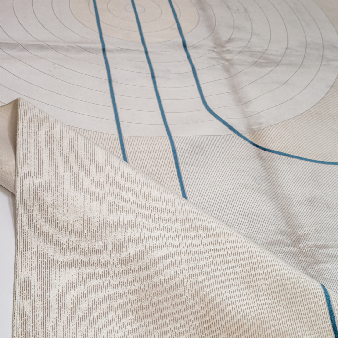 Orrin cotton Rug in 200x300 cm featuring beige and ivory tones with minimal blue line and circle design, made from soft silk blend.