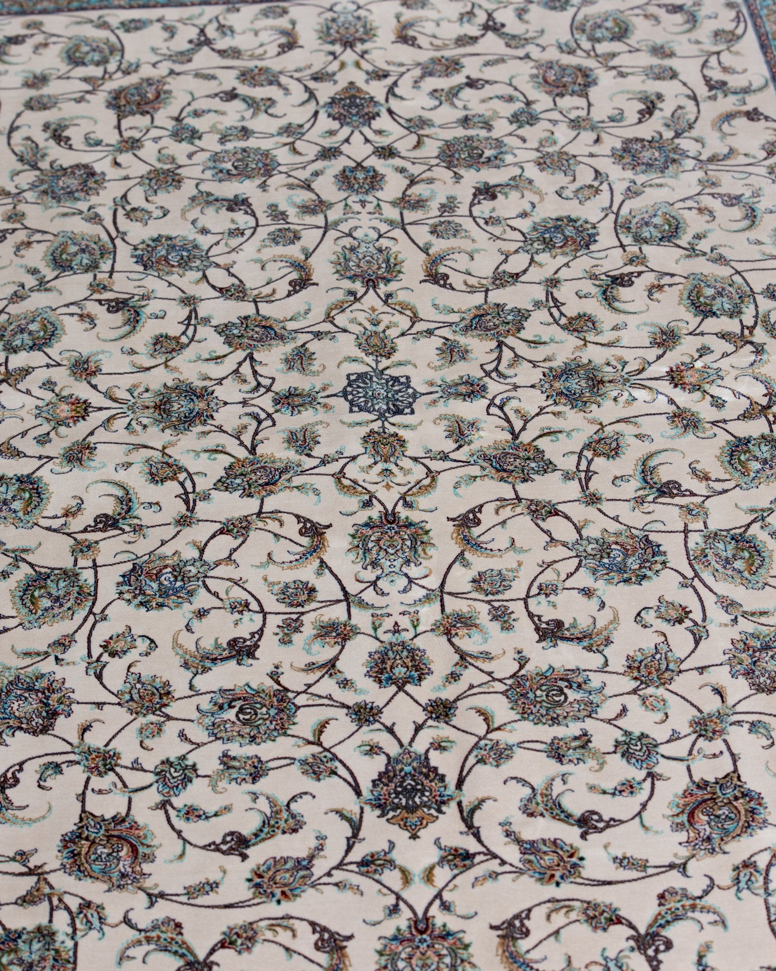 detail of the floral field on the Parisa ivory silk rug