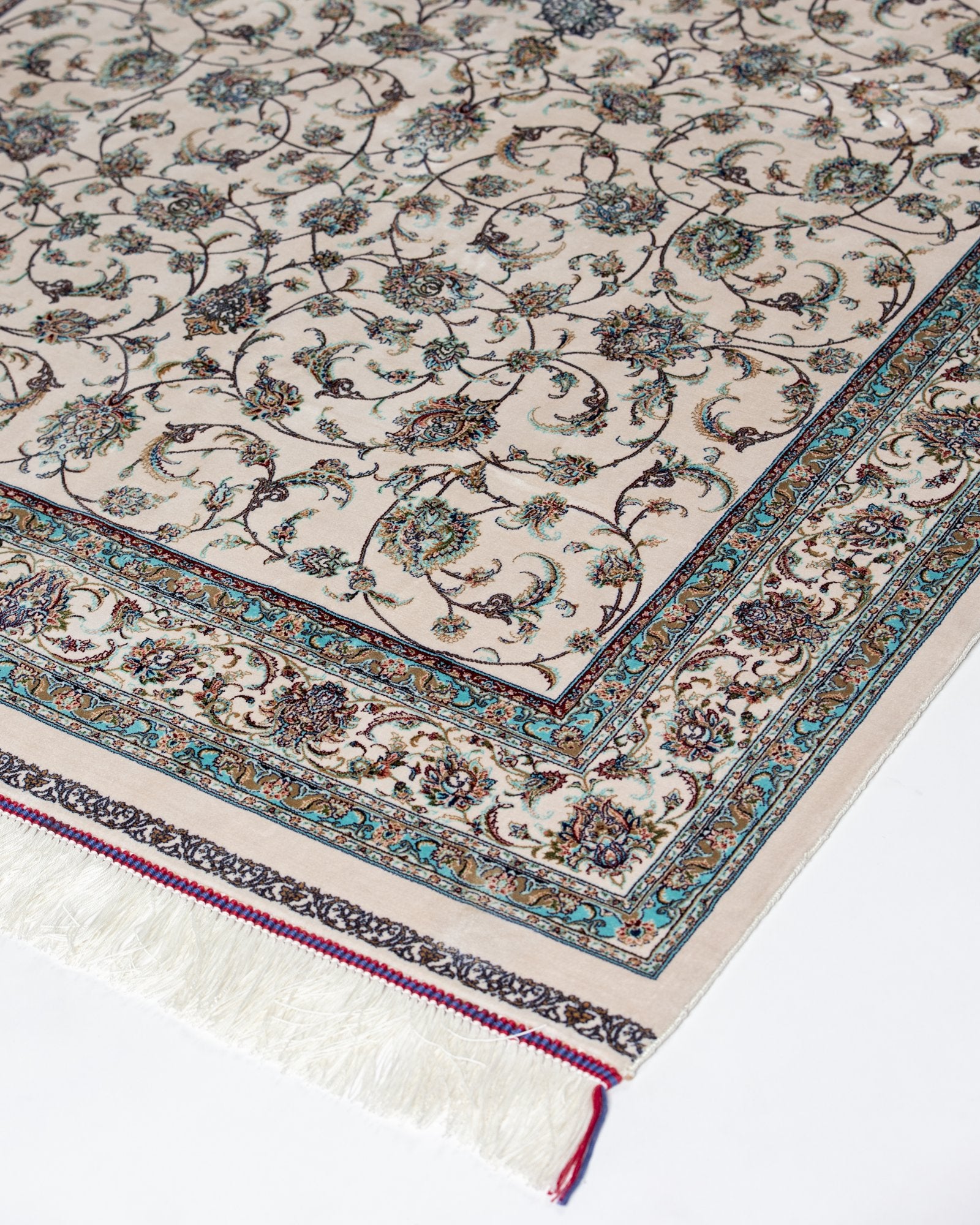 corner with silk fringe on the Parisa ivory silk rug