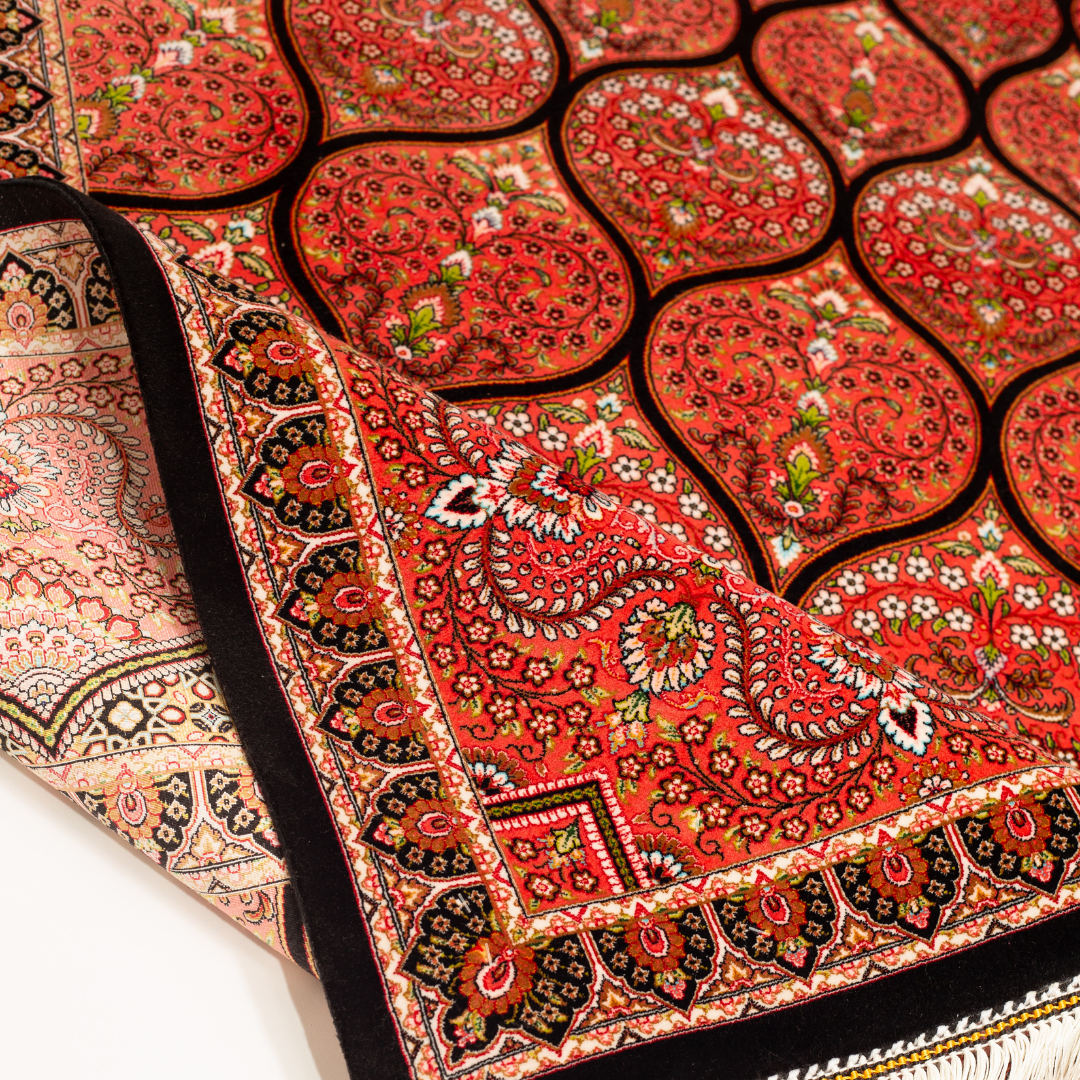 Detailed view of the Sarveen silk rug in 200x300 cms featuring a red medallion pattern with floral motifs and intricate border work.