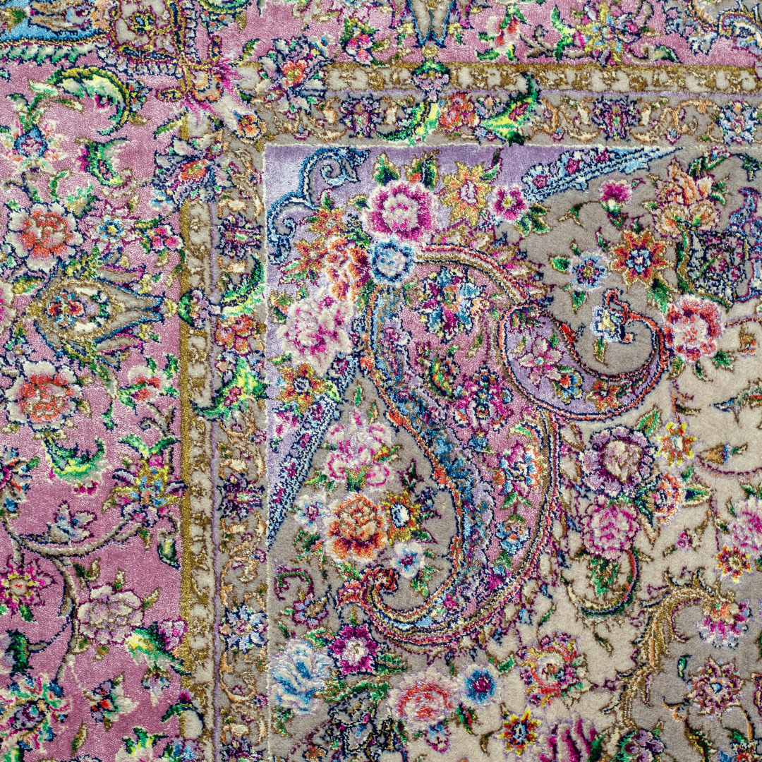 The Savina silk rug features a pink and beige floral medallion design, handwoven in fine silk with intricate detailing.