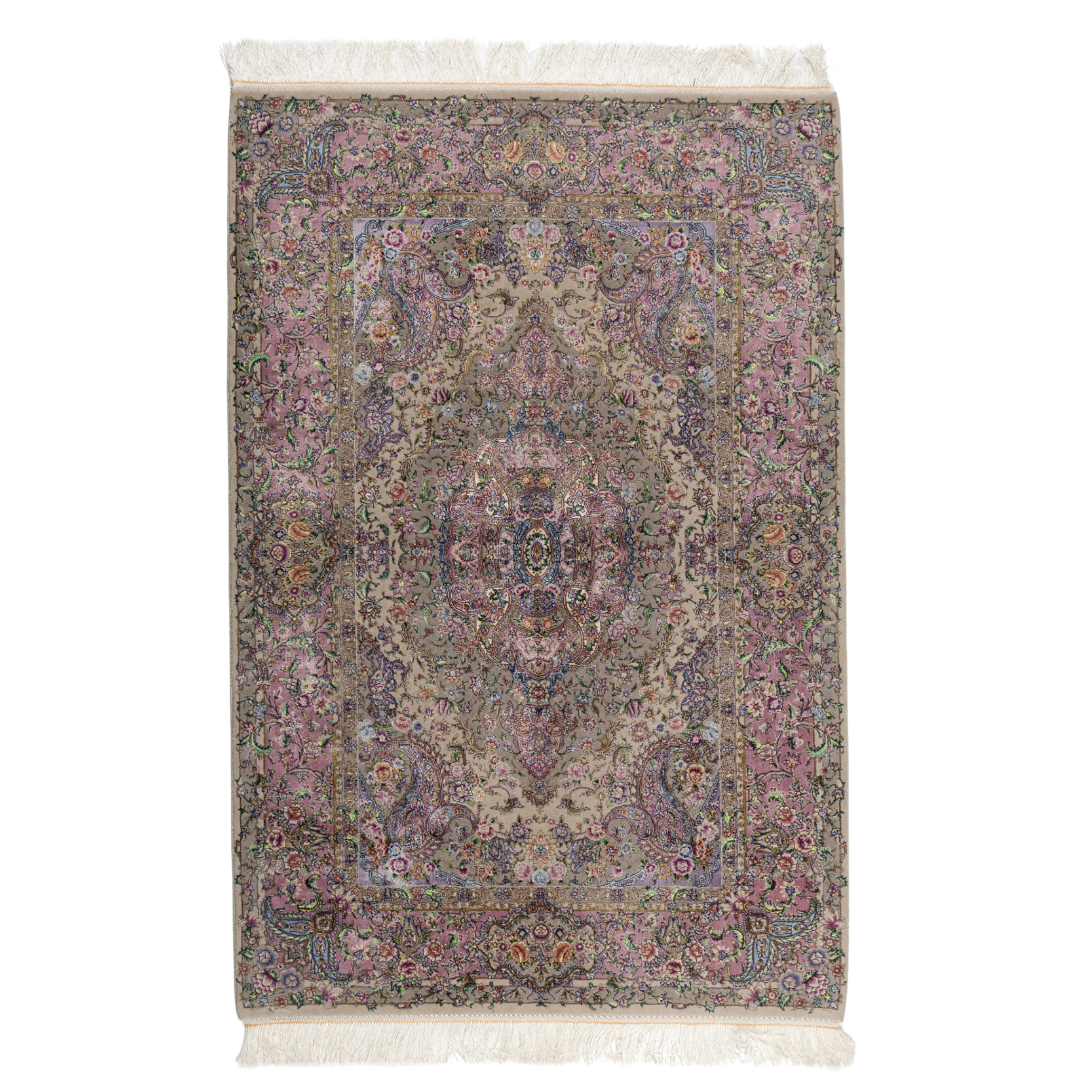 The Savina silk rug features a pink and beige floral medallion design, handwoven in fine silk with intricate detailing.