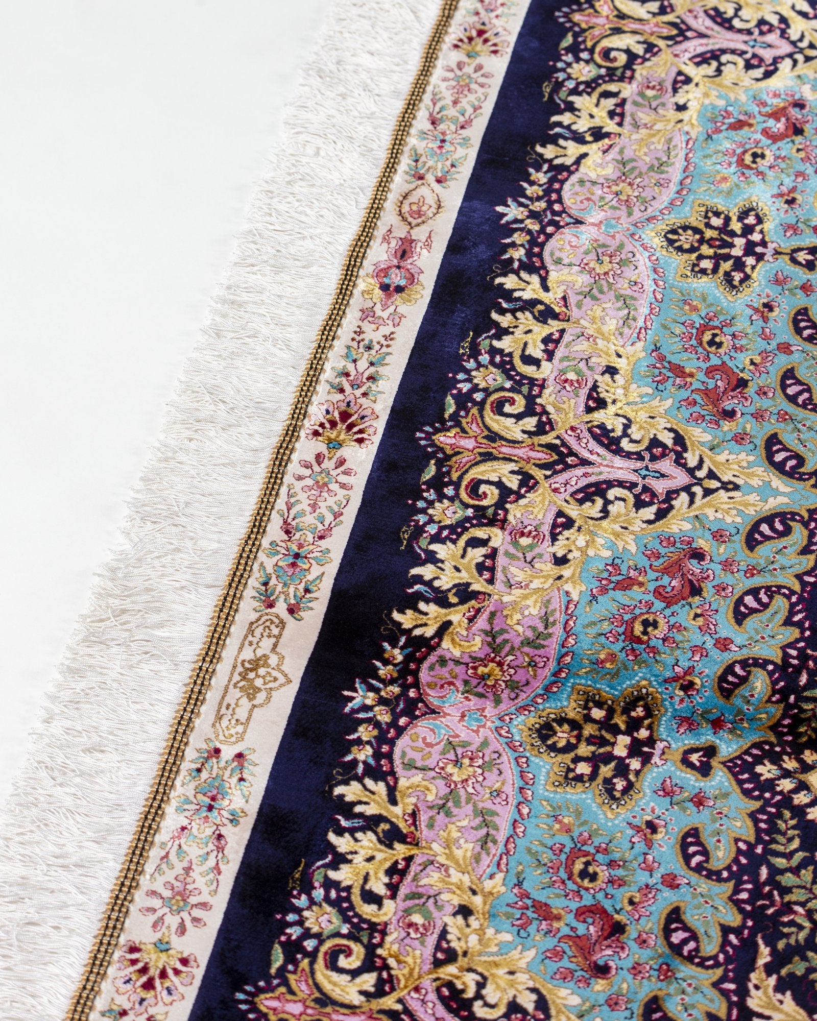 angled view with a fringed end on the Selene charcoal silk rug