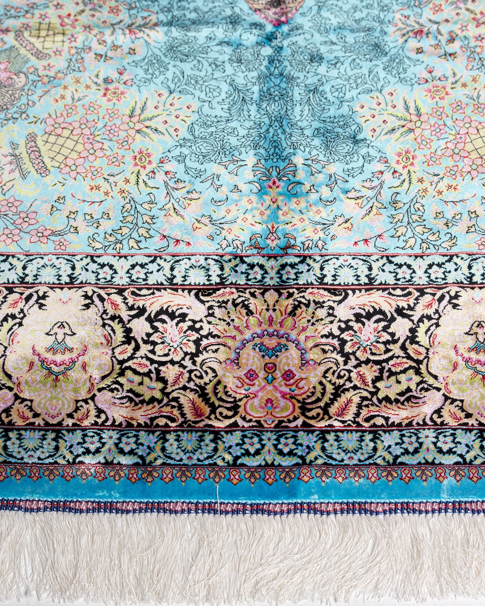 border and field detail on the Serena turquoise silk rug