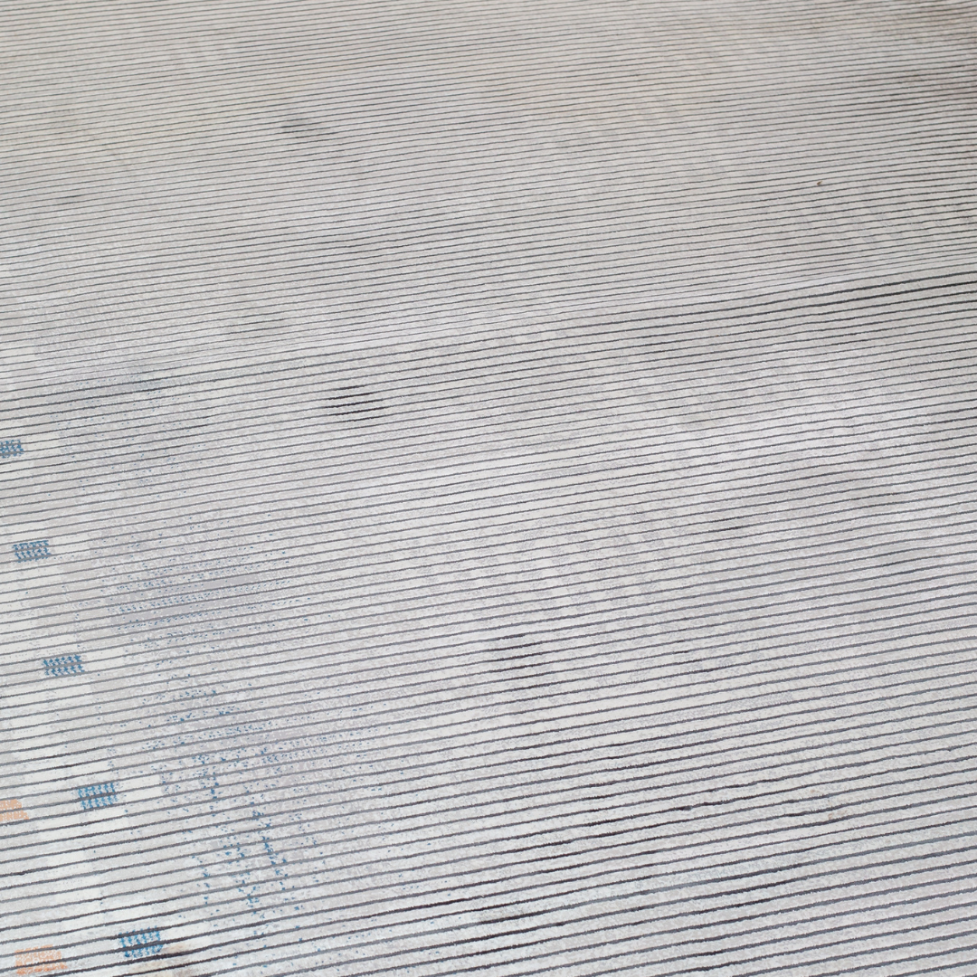 Grey striped Cotton rug with fine orange and blue motif border, in 400x300 cms size, perfect for modern interiors.