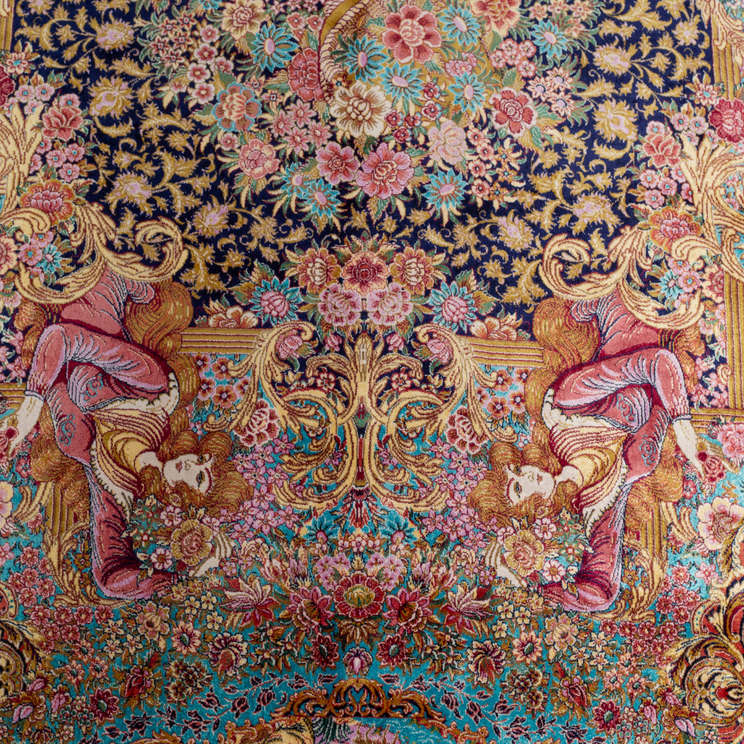 Elegant silk rug in navy, pink, gold, and turquoise with detailed Persian-inspired floral and dancer motifs.