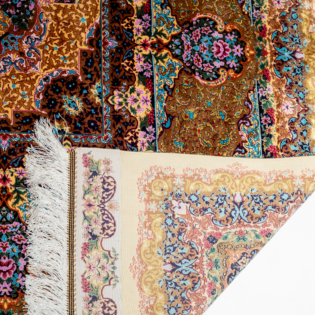 Luxurious silk rug featuring floral medallion pattern in gold, ivory, rose, and turquoise tones with intricate craftsmanship.