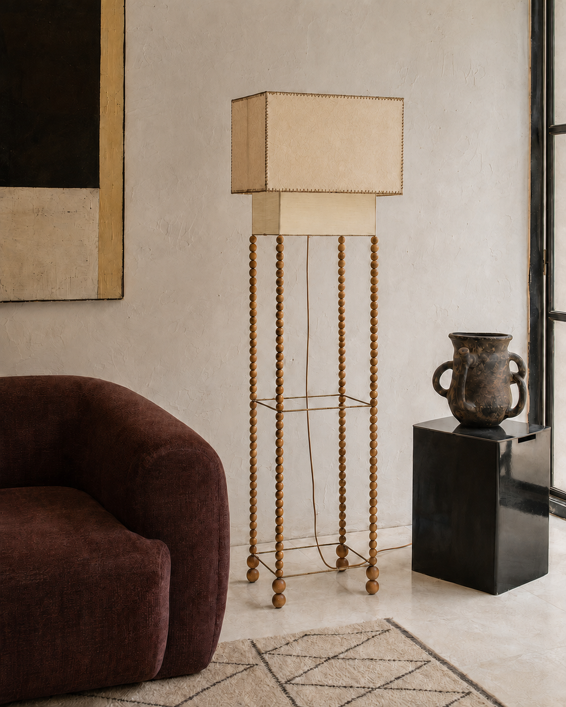 The Abacus Floor Lamp by The Qratist features a handcrafted brass finished metal frame with hand turned wooden spheres and layered parchment paper shades, creating a sculptural floor lamp inspired by the timeless elegance of an abacus.