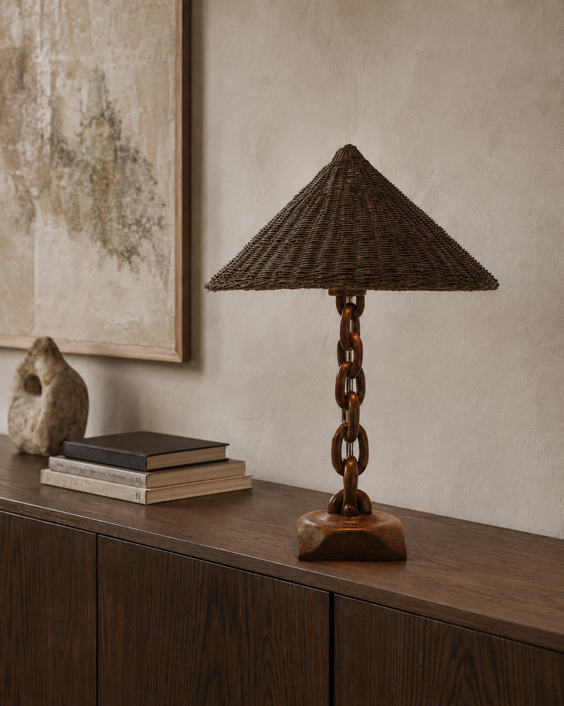 The Anchor Table Lamp by The Qratist features a handcrafted solid wood chain base with a woven wicker shade, creating a warm coastal inspired table lamp with natural ambient illumination.