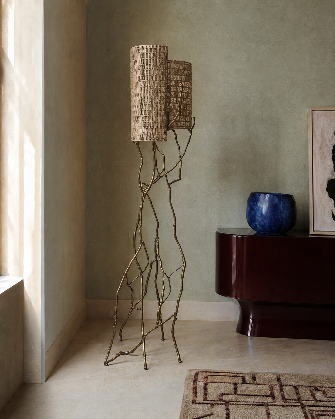 The Banyan Floor Lamp by The Qratist features a sculptural patinated gold brass frame inspired by banyan tree roots with handcrafted woven cane shades, creating a warm and elegant nature inspired lighting statement.