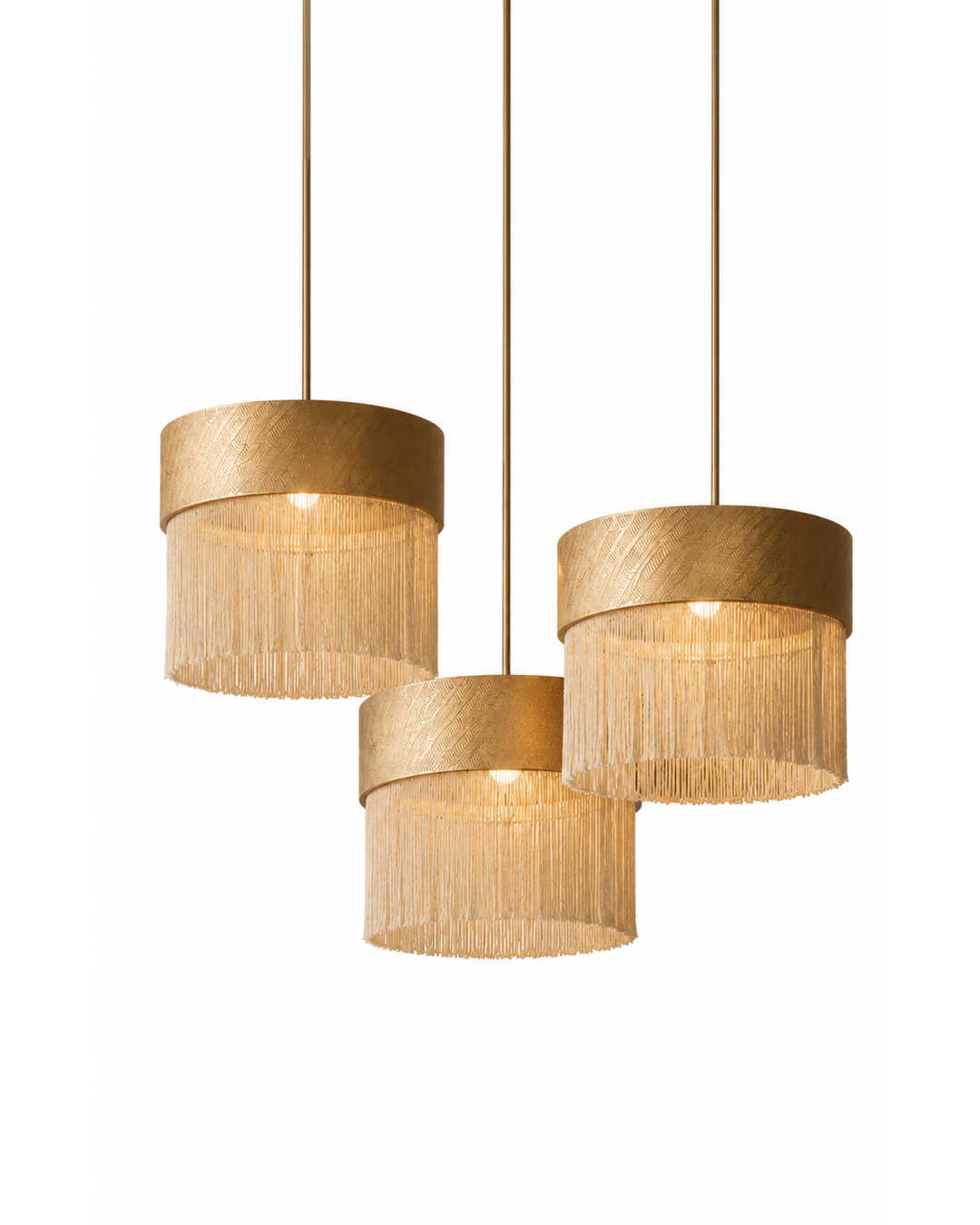 The Cabaret Chandelier by The Qratist features textured cotton pendant shades with cascading fringe suspended from elegant brass fittings, creating a sophisticated Art Deco inspired lighting composition.