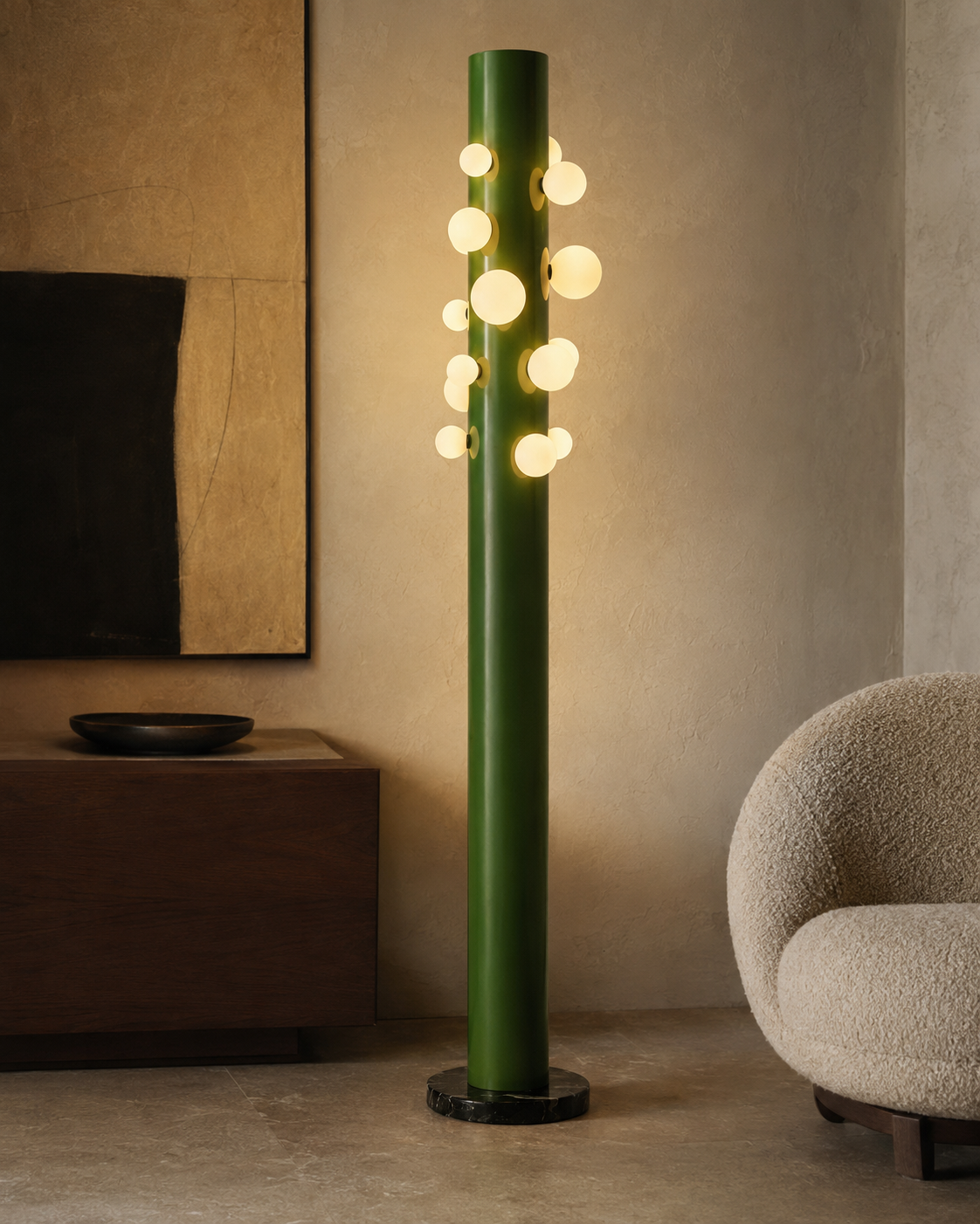 The Cactus Floor Lamp by The Qratist features a sculptural green metal column surrounded by glowing opal glass globes and anchored by a solid black marble base, creating a contemporary botanical lighting statement.