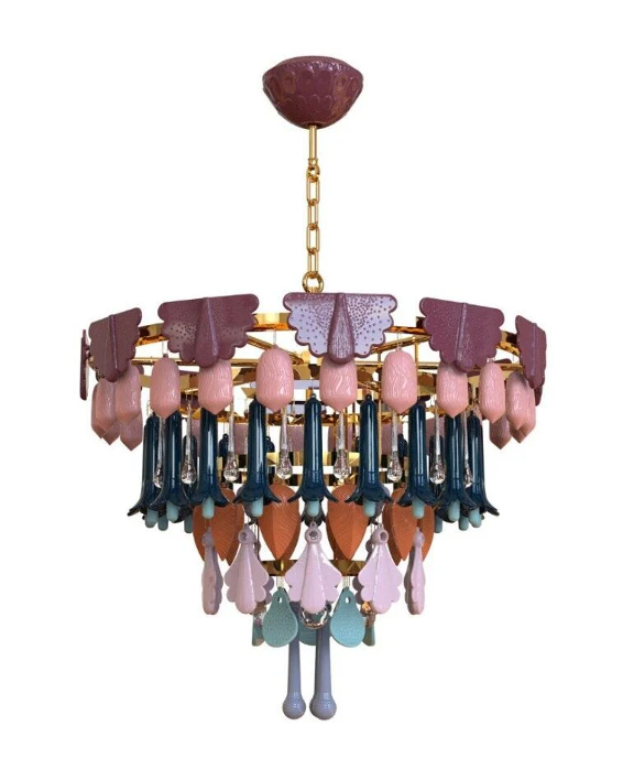 The Canopy Chandelier by The Qratist features handcrafted porcelain petals and coloured glass accents suspended from a gold plated frame, creating a layered botanical statement inspired by a flourishing garden canopy.