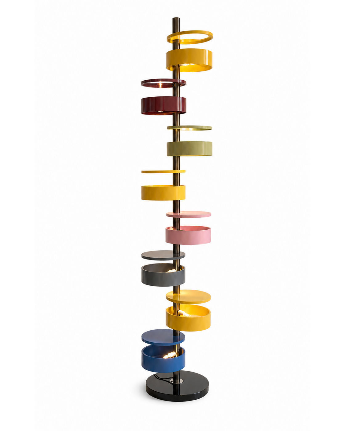 The Crayon Floor Lamp by The Qratist features colourful sculptural metal rings spiralling around a polished central column with a solid marble base, creating a playful contemporary floor lighting statement.