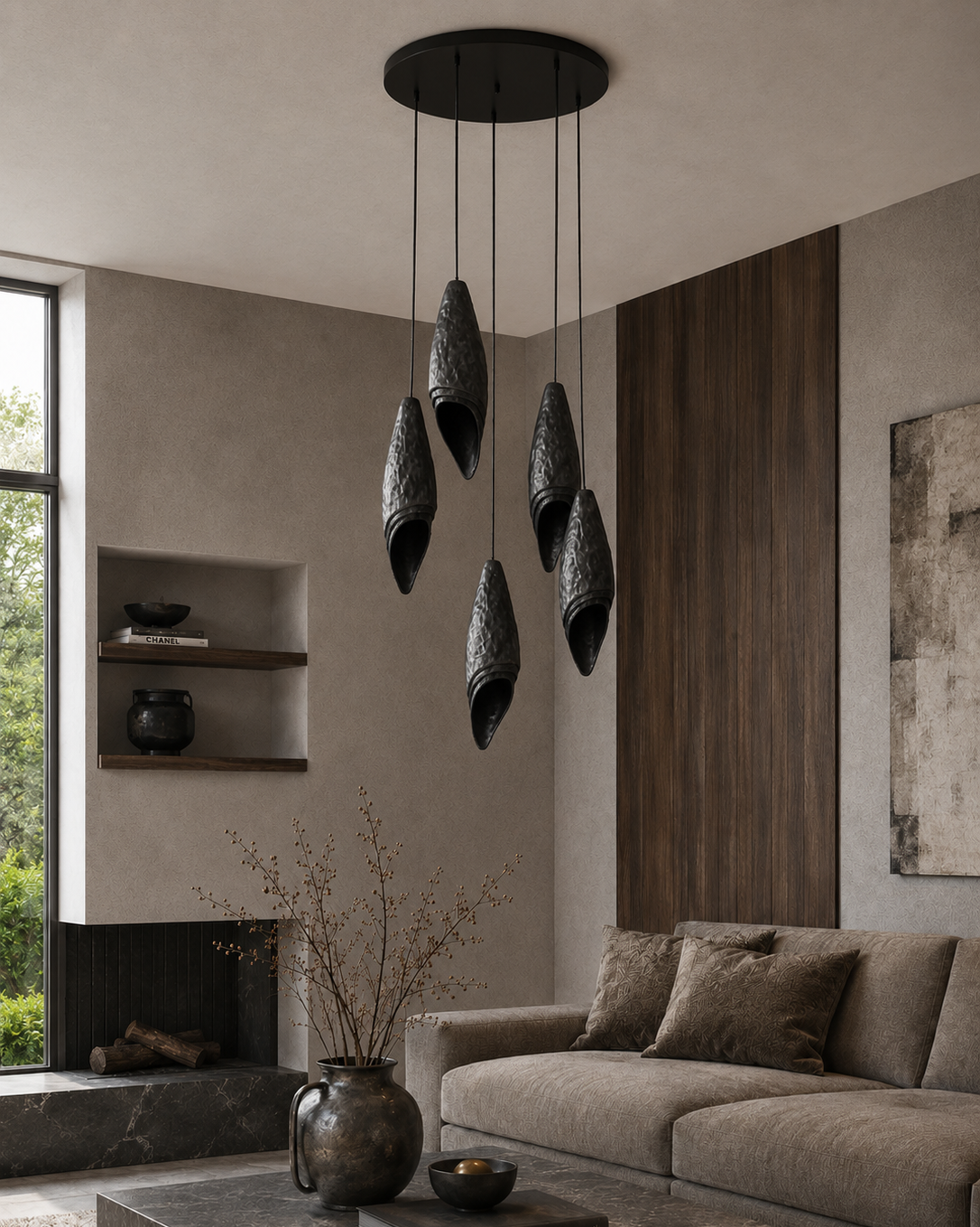 The Eclipse Cluster Chandelier by The Qratist features handcrafted dark gray brass pendants with textured gold interiors suspended in a sculptural clustered arrangement.