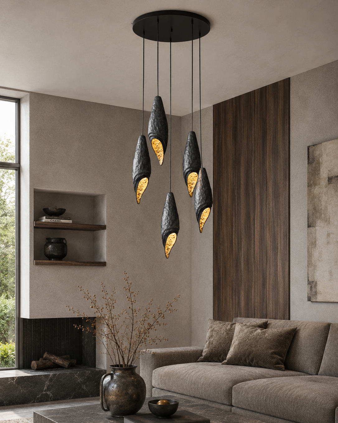 The Eclipse Cluster Chandelier by The Qratist features handcrafted dark gray brass pendants with textured gold interiors suspended in a sculptural clustered arrangement.