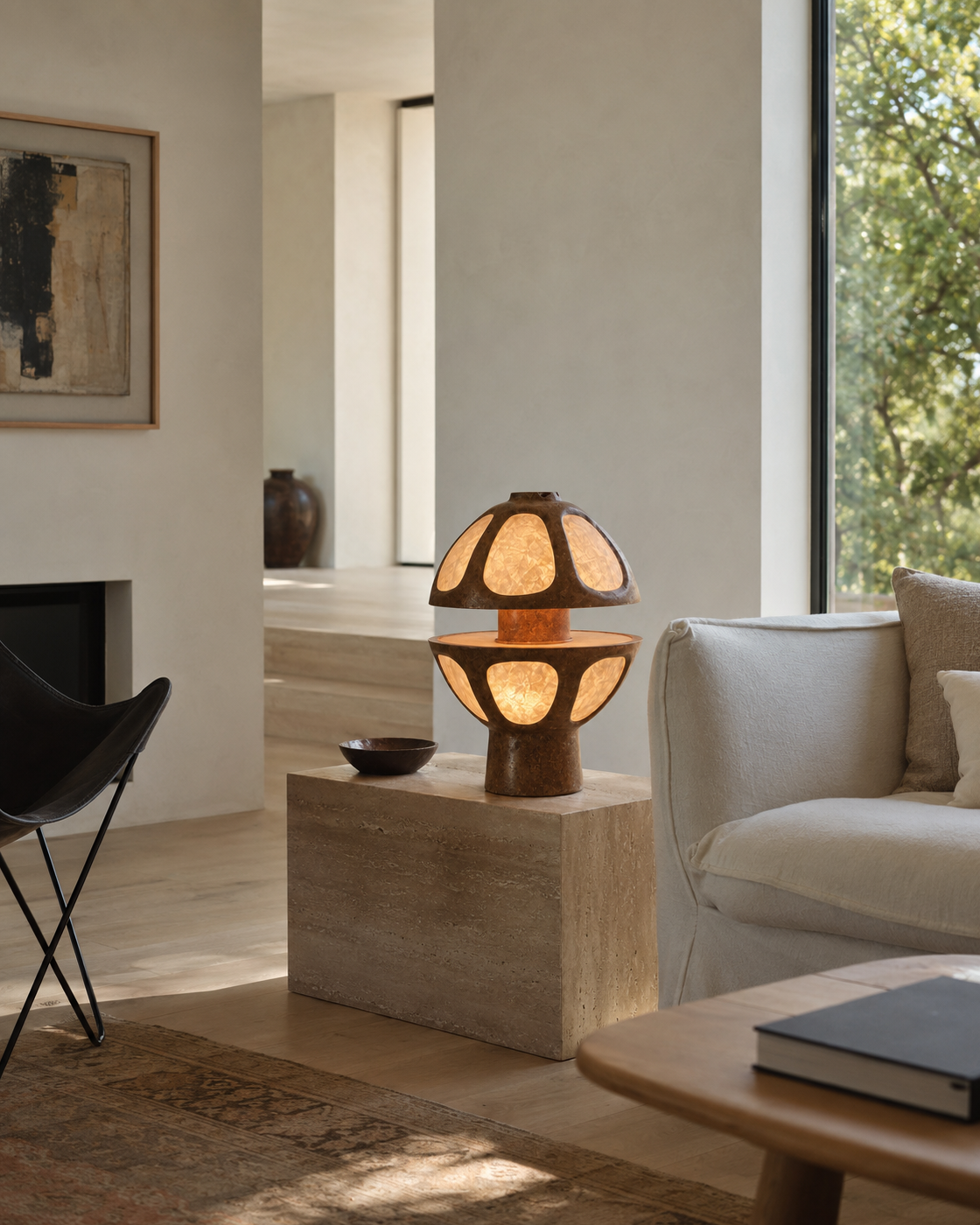 The Fungi Table Lamp by The Qratist features a sculptural mushroom inspired silhouette handcrafted from Unryu rice paper and metal, creating a warm ambient table lamp with soft natural illumination.
