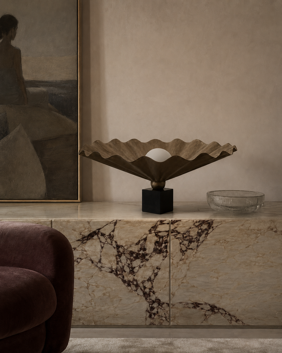 The King Table Oyster Lamp by The Qratist features a handcrafted matt bronze metal form with a sculptural paper diffuser surrounding a glowing central light, creating a refined organic statement table lamp.