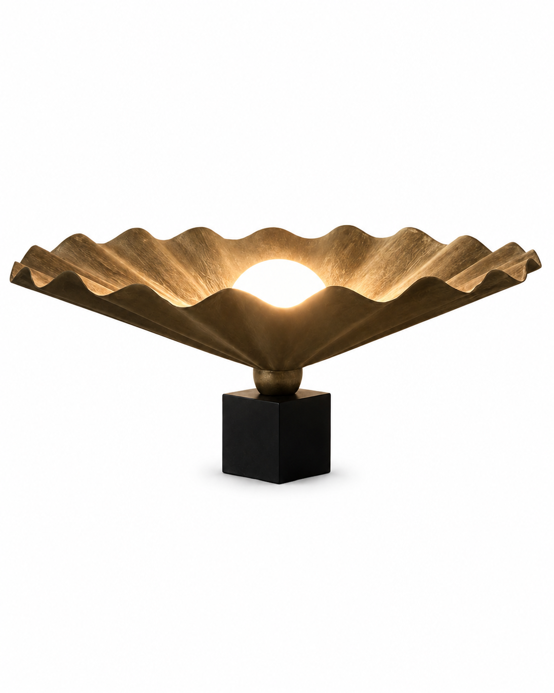 The King Table Oyster Lamp by The Qratist features a handcrafted matt bronze metal form with a sculptural paper diffuser surrounding a glowing central light, creating a refined organic statement table lamp.