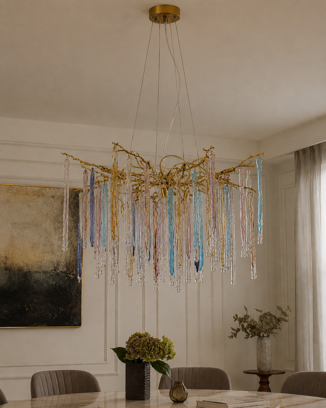 The Kryptonite Chandelier by The Qratist features handcrafted glass rods suspended from an organic brass framework, creating a bold sculptural statement inspired by crystalline formations.