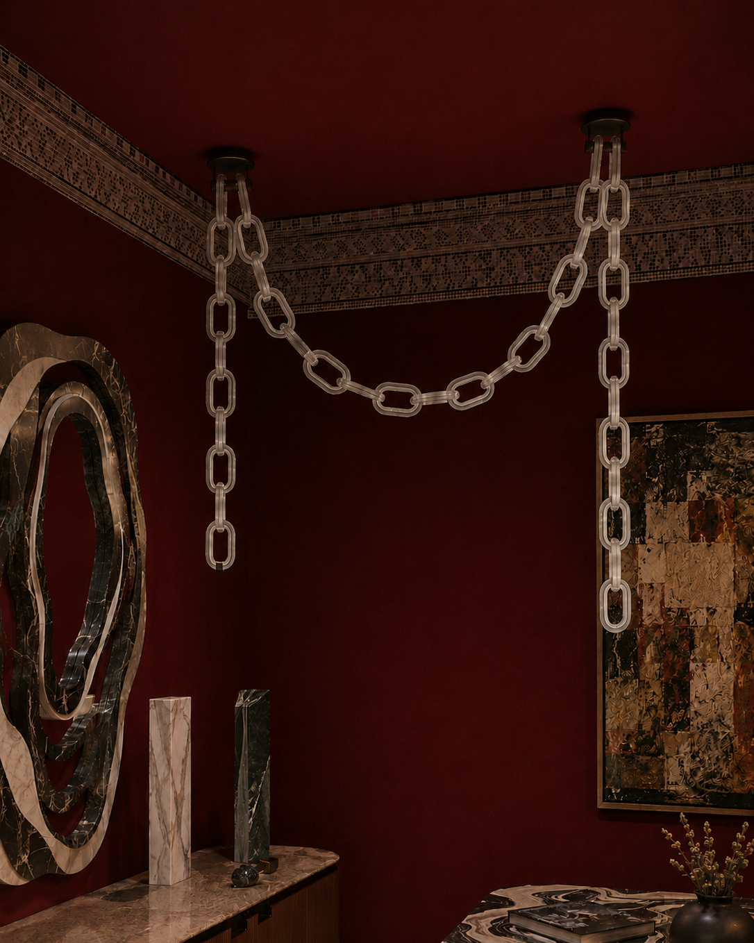 The Linked Chandelier by The Qratist features illuminated glass chain links suspended from a sleek metal frame, creating a bold contemporary architectural statement.