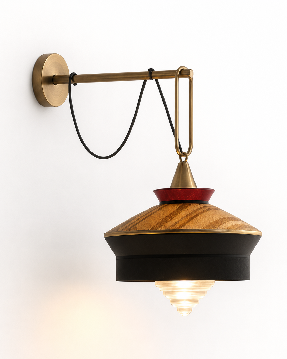 The London Wall Light by The Qratist features handcrafted metal, fabric, and glass in a lantern inspired design that creates warm ambient illumination.