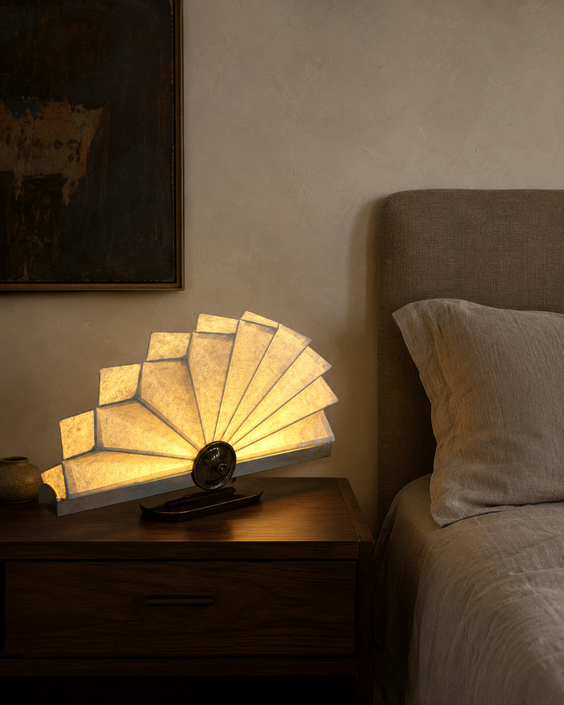 The Operatic Table Lamp by The Qratist features handcrafted paper panels arranged in an elegant fan inspired form with a refined metal frame, creating a sculptural table lamp with soft ambient illumination.