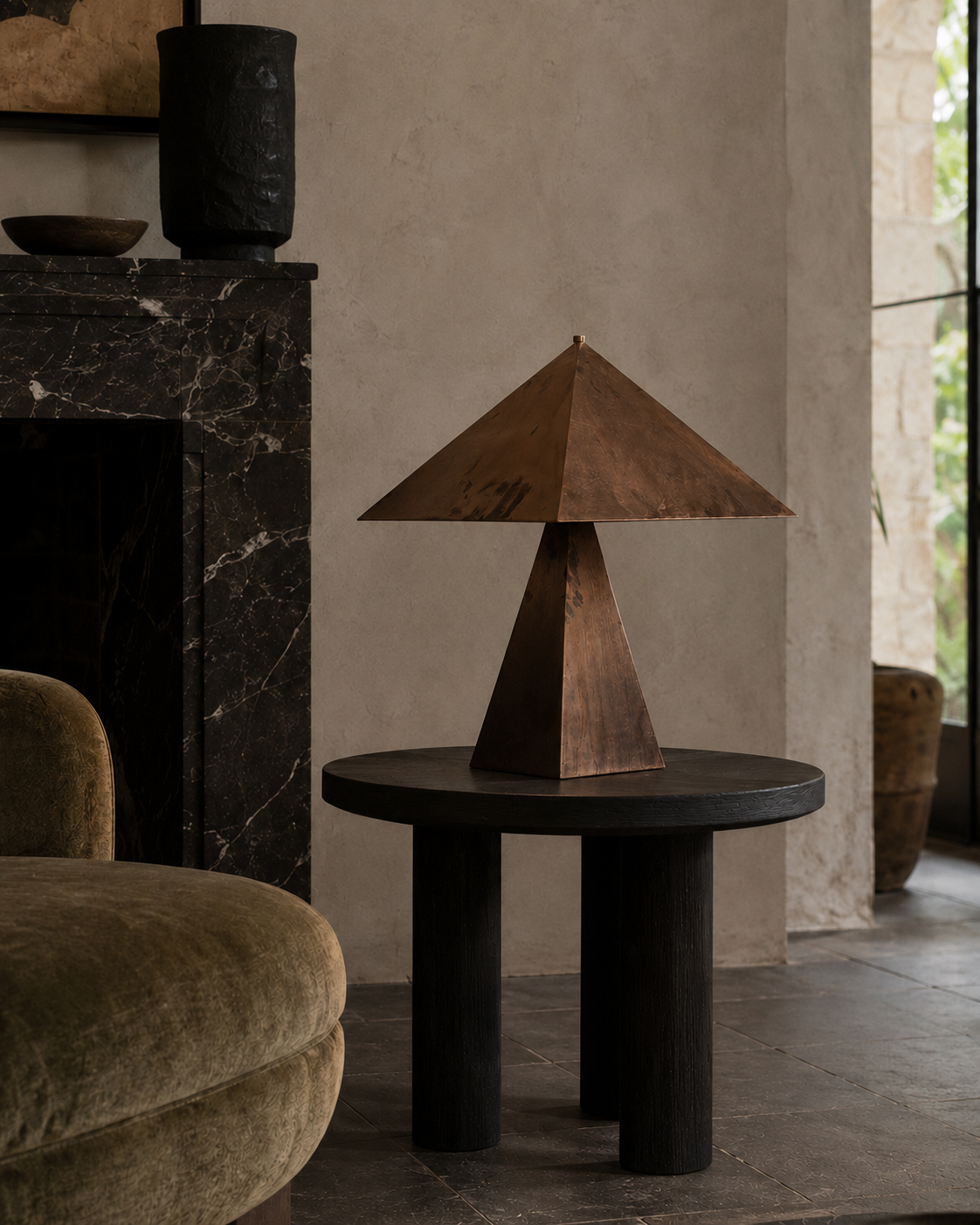 The Oriental Table Lamp by The Qratist features a handcrafted solid copper pyramidal shade and tapered geometric base, creating a timeless sculptural table lamp with warm ambient illumination.