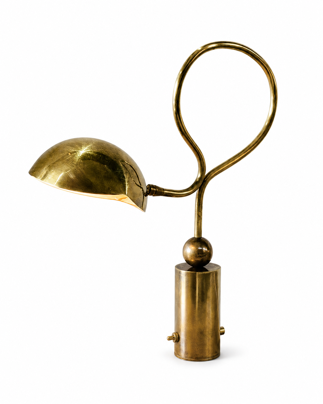 The Serpenti Table Lamp by The Qratist features a handcrafted solid brass looping frame with an adjustable dome shade, creating a sculptural table lamp with elegant warm ambient illumination.