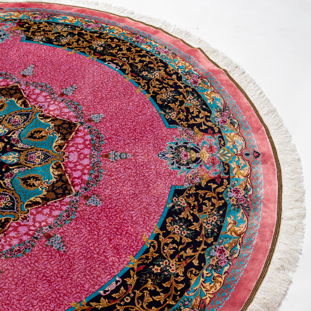 Round silk rug with a vibrant pink base, intricate navy floral borders, and detailed medallion center, 200x200 cm.