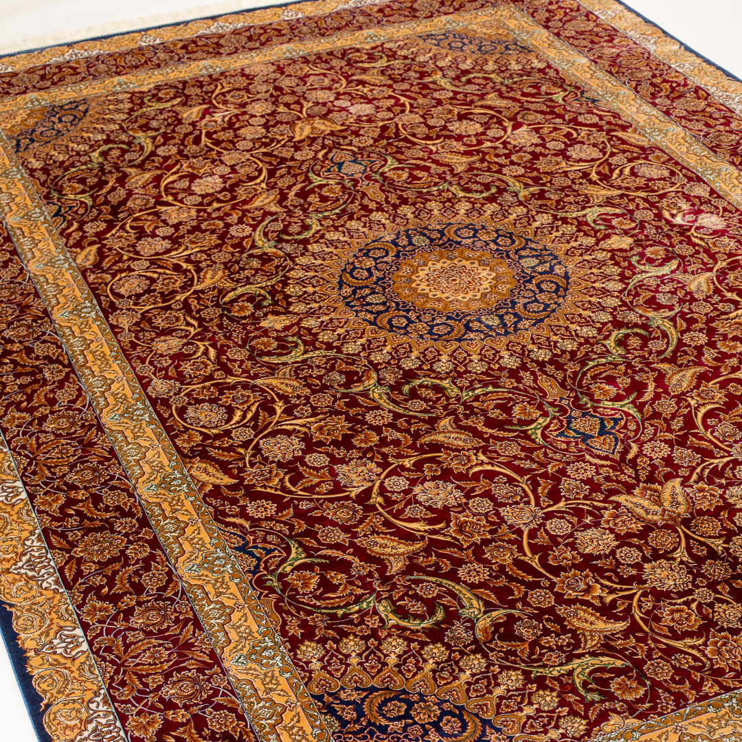 Zavira Silk Rug in 200x300 cm with crimson red base, ornate golden floral patterns, navy accents, and intricate woven detailing.