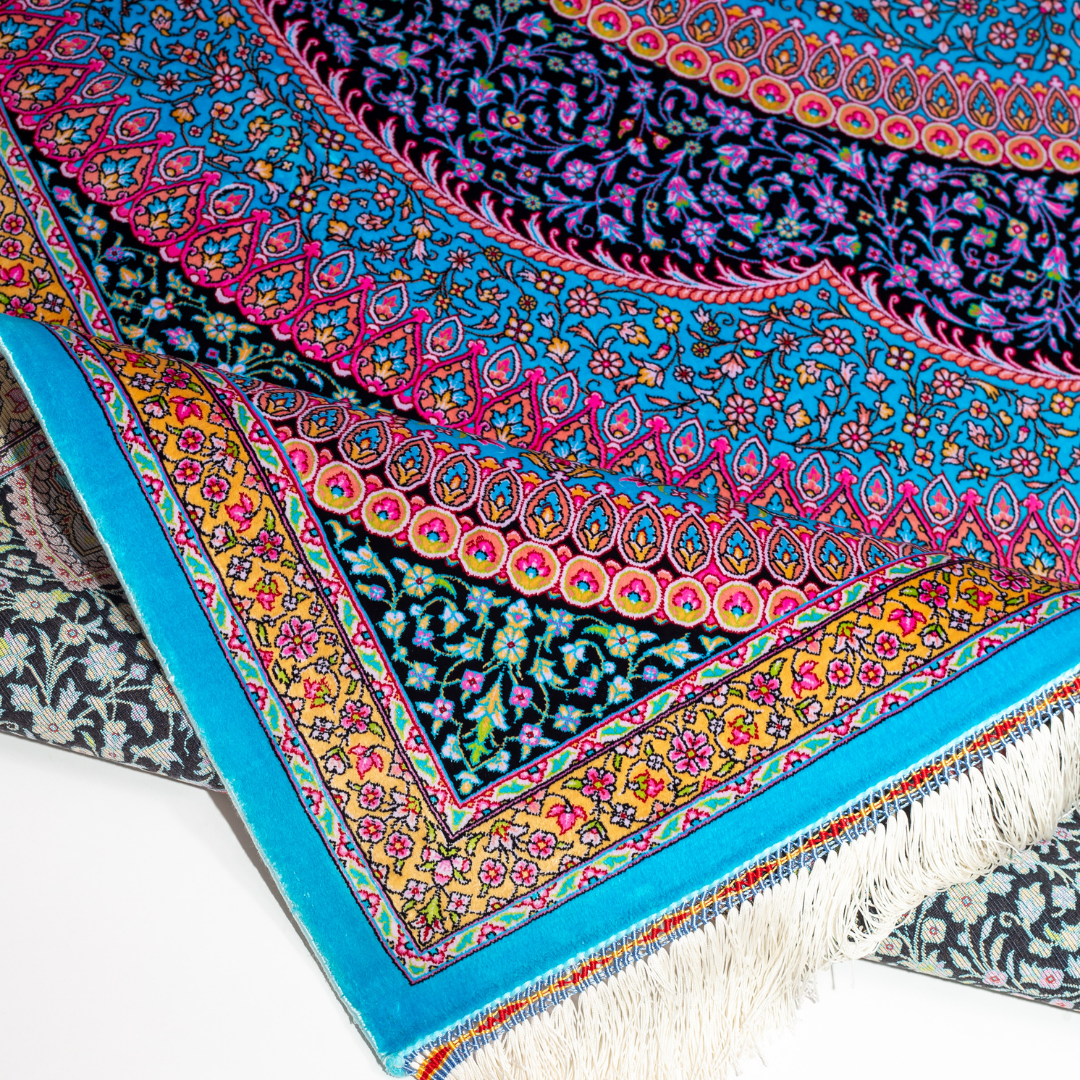 Luxurious silk rug in turquoise with intricate medallion and floral patterns, perfect for refined interiors.